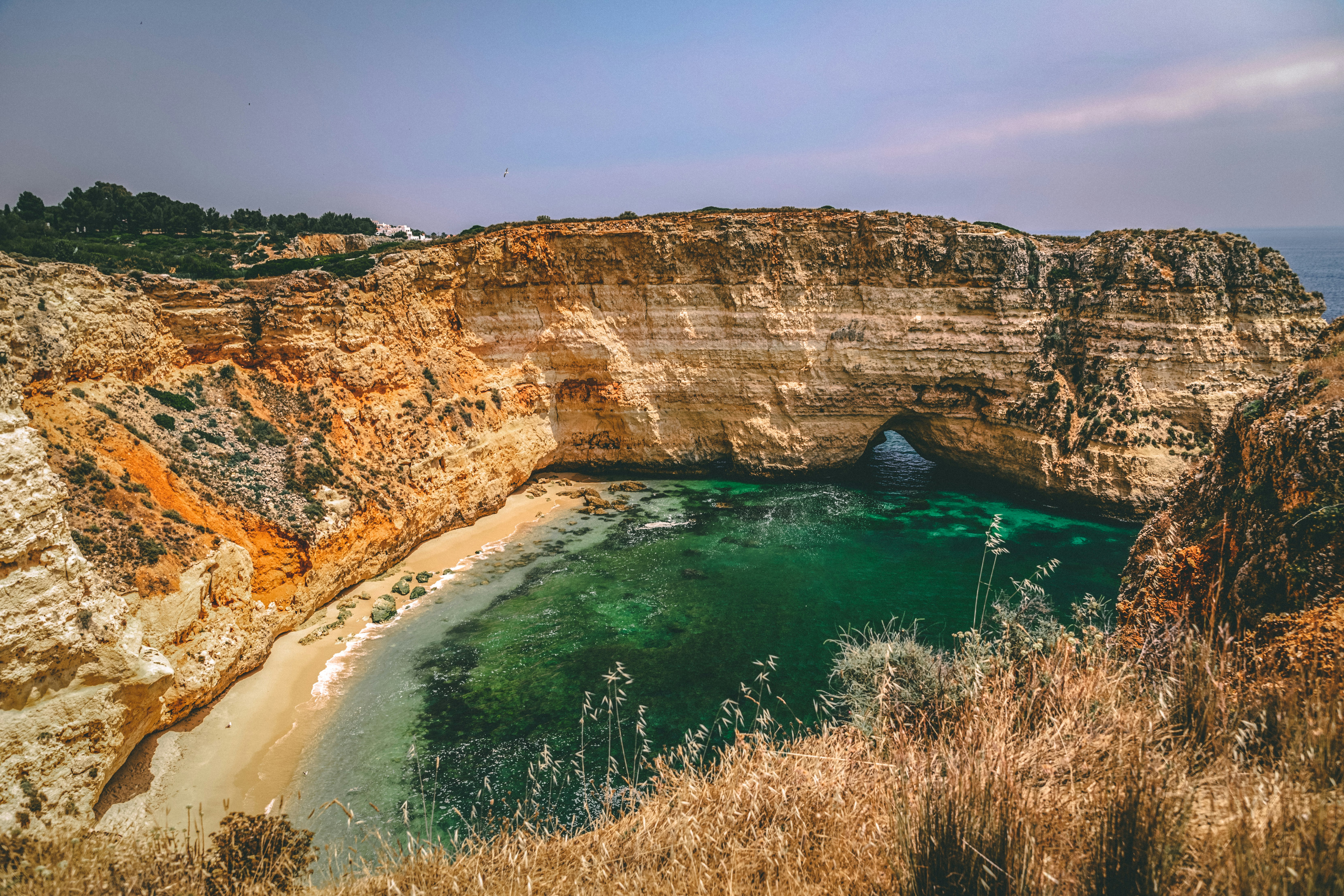 brown rock formation beside blue sea during daytime